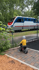 Child watches trains from playground in Ufa, Russia