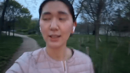 Woman Records Selfie Video in Paris Park During Evening Hours