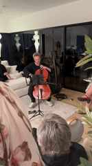 Late-night cello practice in an LA apartment with a city view