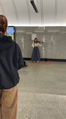 Woman performs violin music at subway station