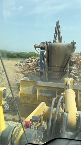 Construction worker operates rock crusher in Bulgarian village