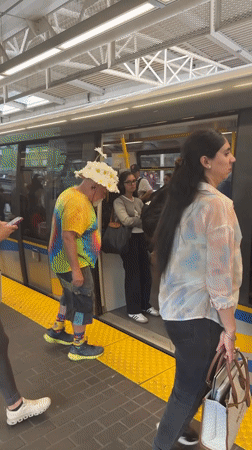 Colorful commuter boards a New Westminster train
