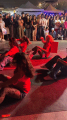 Synchronized dance crews perform at night in Lima