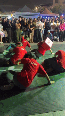 Synchronized dance crews perform at night in Lima