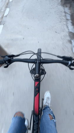 Early morning bicycle ride captured on Chepelare sidewalk