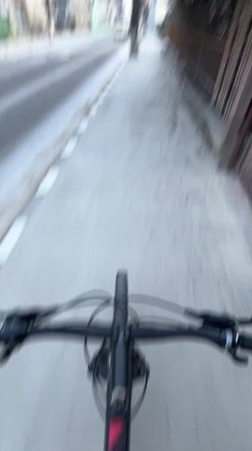 Early morning bicycle ride captured on Chepelare sidewalk