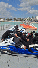 Men in athletic wear gather at sunny Ayia Napa beach resort