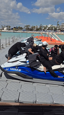 Men in athletic wear gather at sunny Ayia Napa beach resort