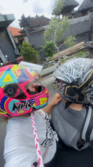 Motorcyclists record street video in Mengwi, Indonesia early morning