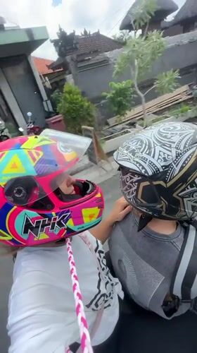 Motorcyclists record street video in Mengwi, Indonesia early morning