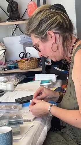 Artisan crafts jewelry at outdoor market in Montbrison