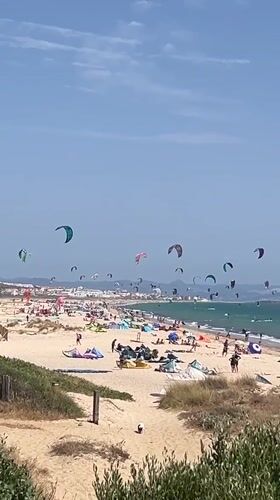 Tarifa beach in full summer swing: kites, crowds, and character