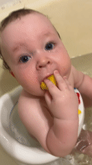Mother bathtime routine with baby documented in Марковский, Russia