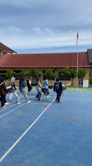 Marching band practice on a school's outdoor court