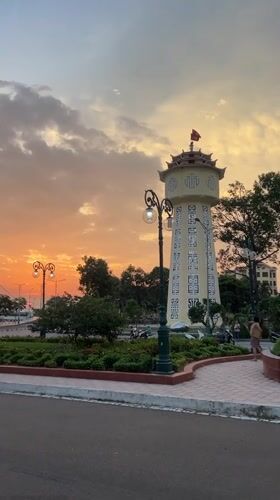 Sunset over a Vietnamese city skyline, street level