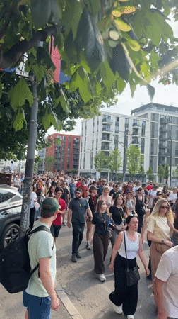 Demonstrators march through Belgrade streets carrying Serbian flags