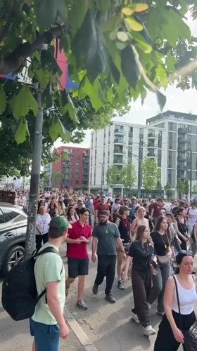 Demonstrators march through Belgrade streets carrying Serbian flags