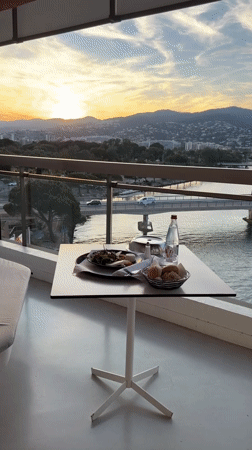 Balcony dining scene captured in French Riviera town