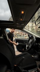 Man enters car with drink, plastic bag in Tbilisi