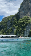 Tour boats and snorkeling around Ao Nang limestone cliffs