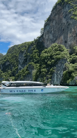 Tour boats and snorkeling around Ao Nang limestone cliffs