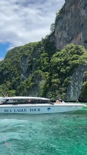 Tour boats and snorkeling around Ao Nang limestone cliffs