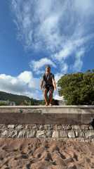Man performs backflip from ledge onto Petrovac beach