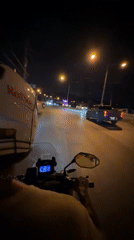 Motorcyclist in RedSuns helmet rides through Kamala, Thailand