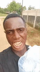 Man poses with household objects in Akwete, Nigeria
