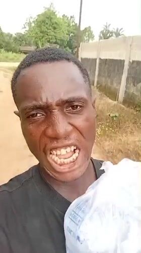Man poses with household objects in Akwete, Nigeria
