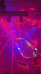 Late-night club session in Riga, DJ, smoke, and colored lights