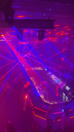Late-night club session in Riga, DJ, smoke, and colored lights