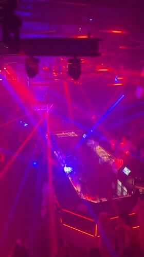 Late-night club session in Riga, DJ, smoke, and colored lights