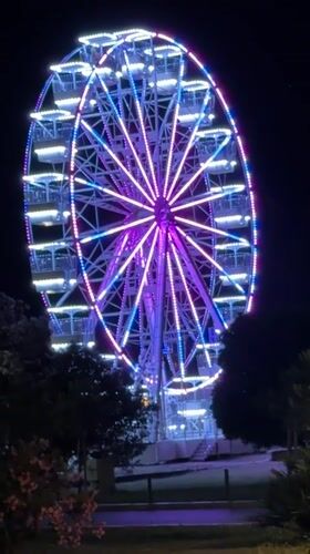 Nighttime scenes documented across Budva, Montenegro showing Ferris wheel, taxis