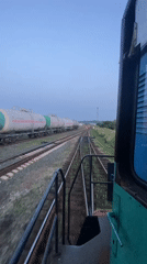 Train moving through Kauchuk Stantsiya at dusk, Russia