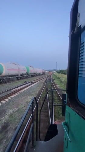 Train moving through Kauchuk Stantsiya at dusk, Russia