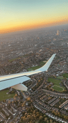 Aerial view captures London cityscape during golden hour from aircraft