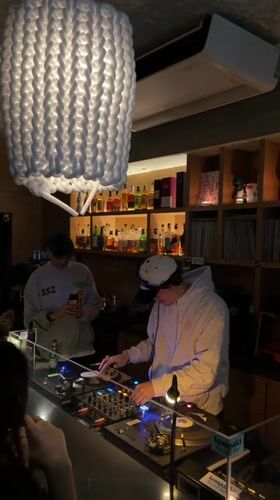 DJ performs with turntables at Seoul bar