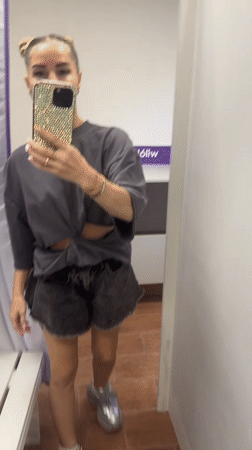Woman tries on rhinestone sneakers at Abakan store
