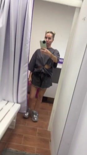 Woman tries on rhinestone sneakers at Abakan store