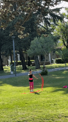 Young gymnast practices ribbons routine in Budva park