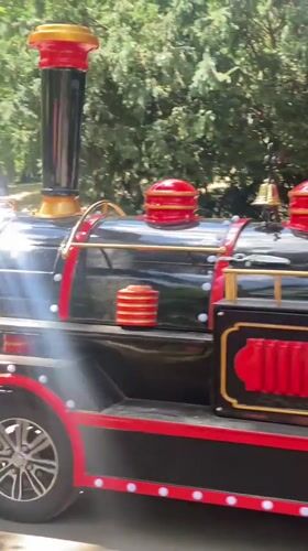Miniature train and carousel at an outdoor Belgrade amusement spot