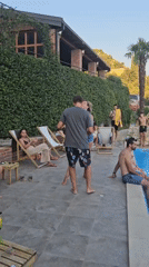 Relaxed poolside gathering with dancing, swimming, and scenic surroundings.