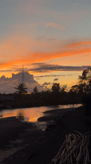Colorful sunset over a river in Meunasah Pupu, Indonesia