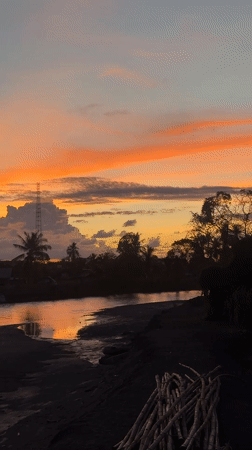 Vivid sunset over a river in Meunasah Pupu, Indonesia