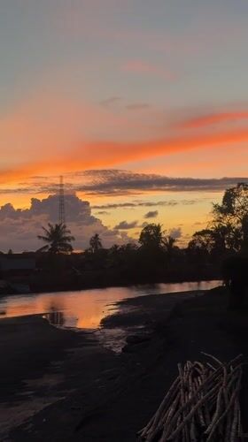 Colorful sunset over a river in Meunasah Pupu, Indonesia
