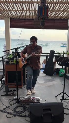 Beachfront gathering with live music and dining captured in Kuta
