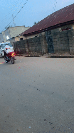 Street scene captured in Akwanga shows van, motorcycle, running boy