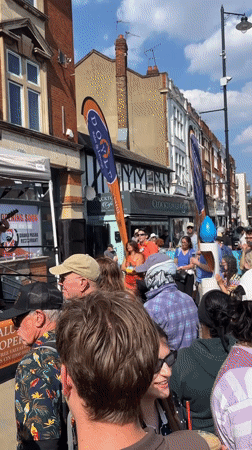 Lei-wearing performers draw crowd at London outdoor festival