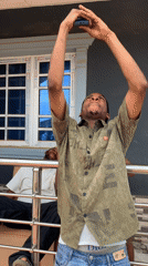 Man photographs companions on couch in sunny Ikorodu scene